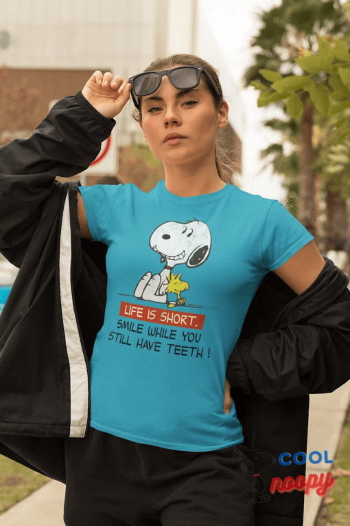 Snoopy Smile Unisex Softstyle T-Shirt Share a Grin with Everyone's Favorite Beagle - Ideal for Fans of All Ages and Happy Moments!